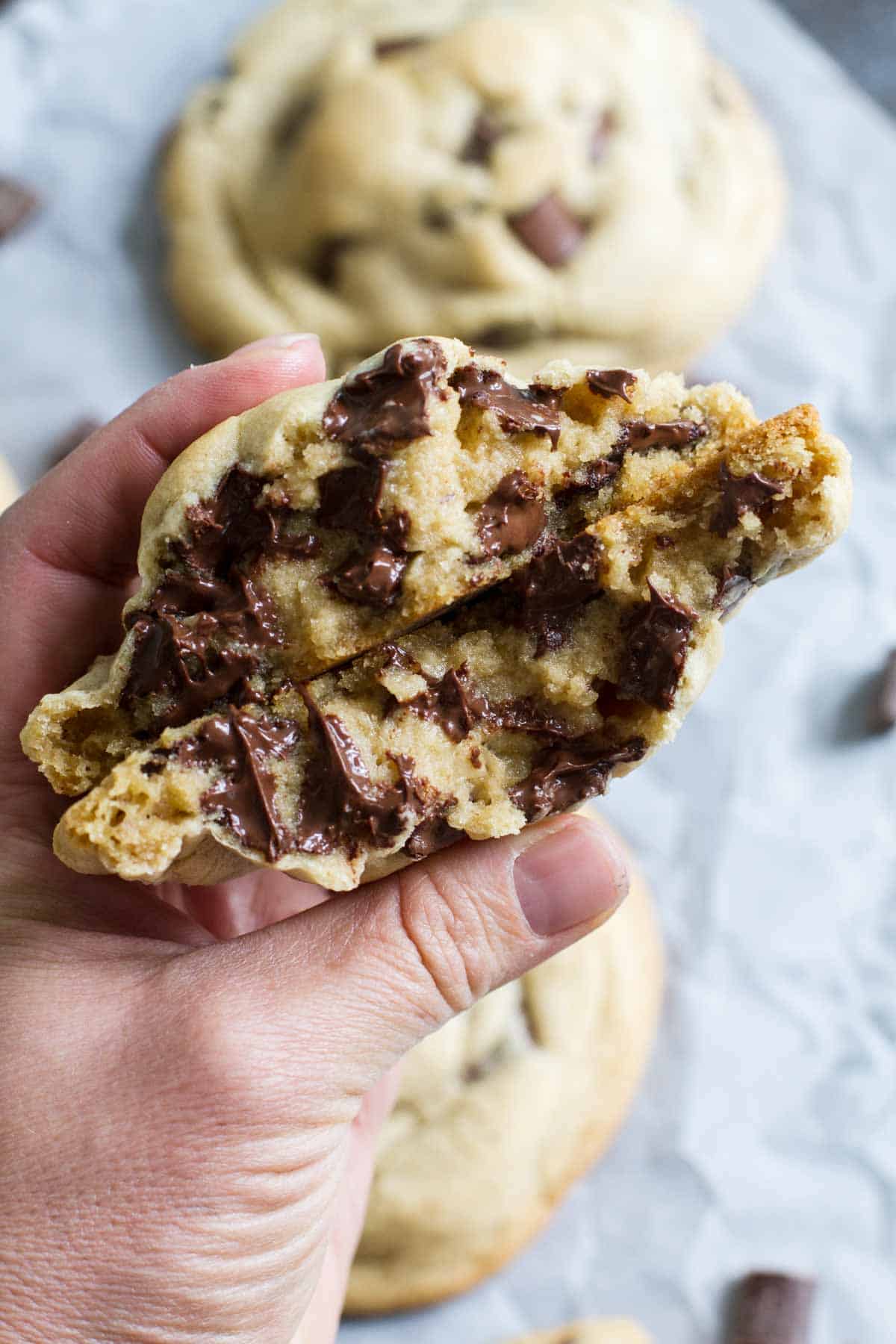 Stuffed cookie pulled apart with stretchy molten chocolate