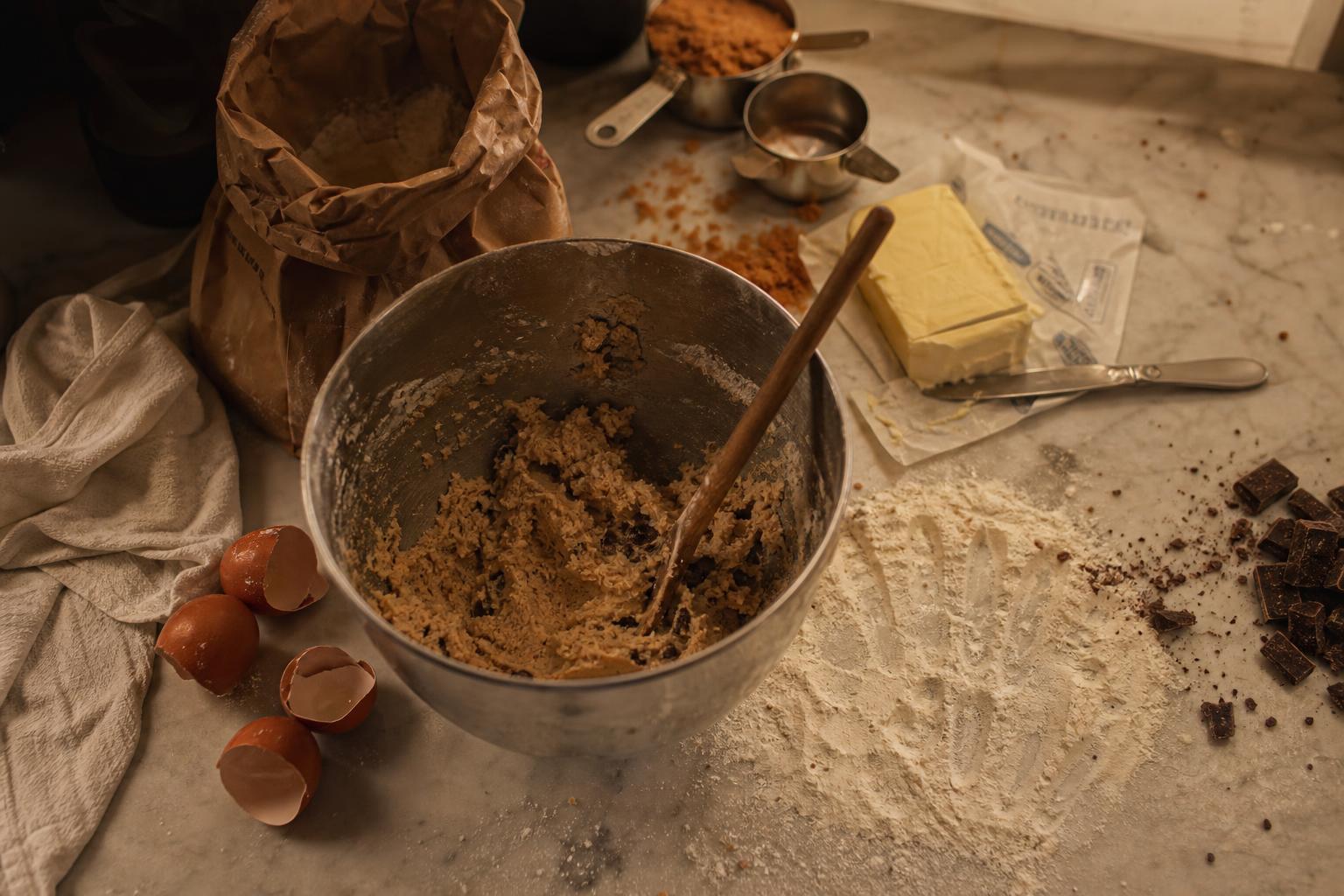 Baking ingredients on warm linen — flour, eggs, chocolate